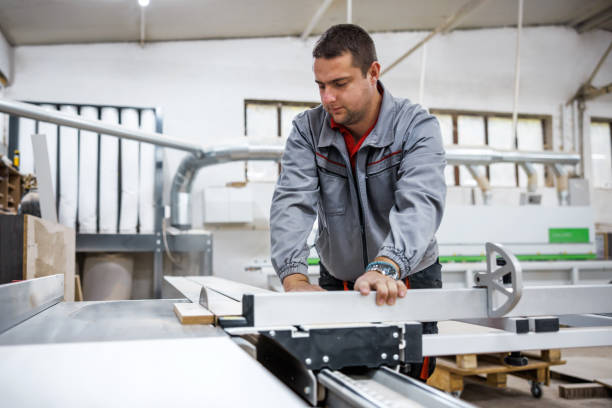 istock Technician works on table saw in factory 1811632581
