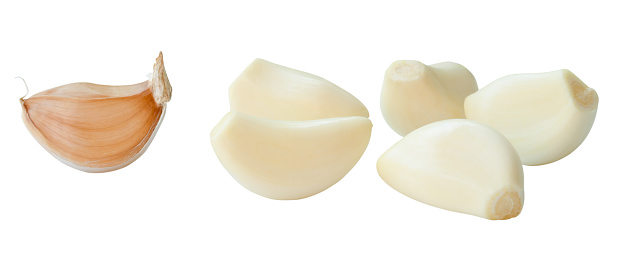 Set of Peeled and unpeeled separated garlic cloves is isolated on white background with clipping path.