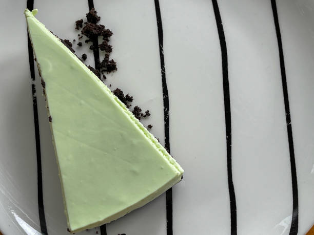 Slice of Green tea matcha cheese cake on ceramic plate