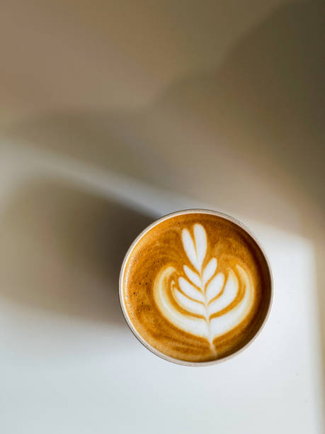 istock Coffee with heart shape latte art on white coffee table 1811652235