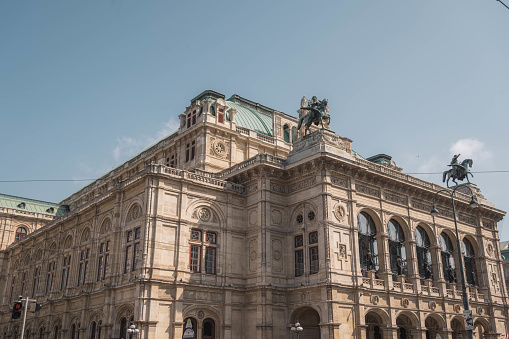 Vienna, Austria - April 9, 2012: Sculpture in front of Albertina museum in Vienna. It was part of Hofburg imperial palace and now it houses one of the largest and most important print rooms in the world. It is located in central Vienna. On this photo is terrace of museum where many people rest and look at the opera across the street.