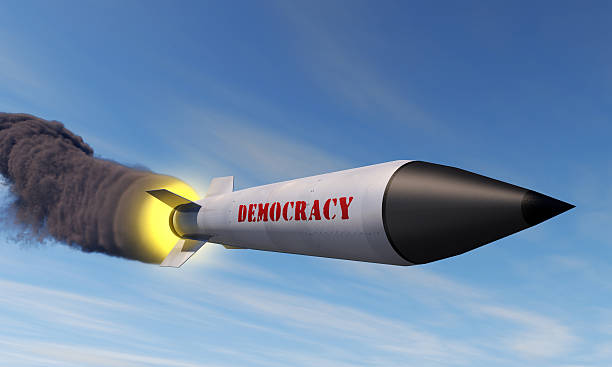 Exporting democracy A missile with a trail of smoke and the word democracy in the side american propaganda stock pictures, royalty-free photos & images