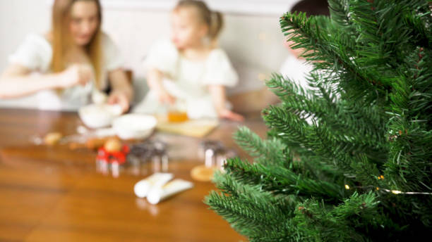 a family of three preparing baking dough - two parent family indoors home interior domestic kitchen imagens e fotografias de stock