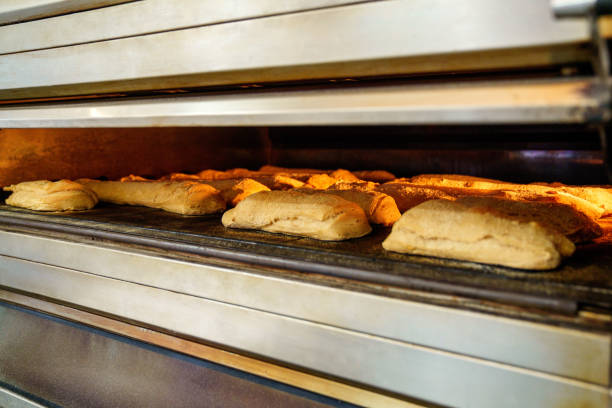 istock Golden Breads Baking in Industrial Oven at Artisan Bakery 1811691221