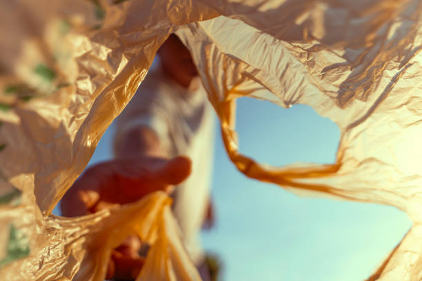 istock Volunteer men Collect plastic bags at public parks for zero-waste, garbage and pollution, global warming, and climate change. 1811694231