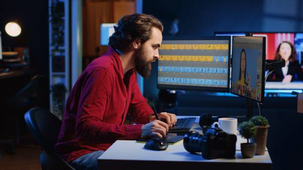istock Photo editor enhancing images with precision using graphic tablet in modern studio 1811694317