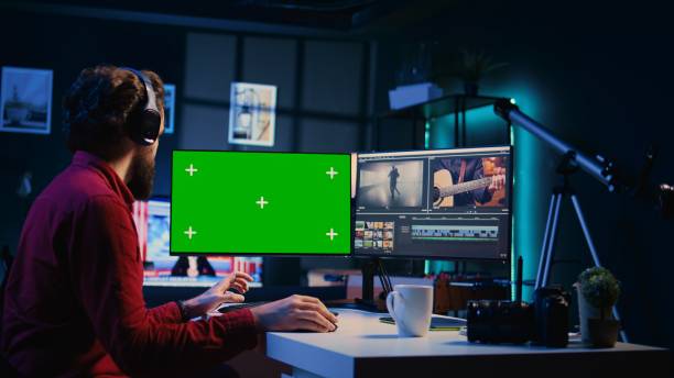 istock Photo editor selecting best photographs using retouching application on chroma key display 1811694545