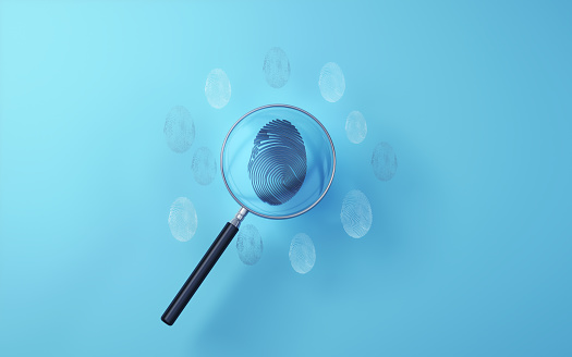 3d Render Black Metallic Fingerprint examined with metallic magnifying glass on soft blue background, Concepts such as occupational safety, cyber crimes, detective work, investigation(Close-up)