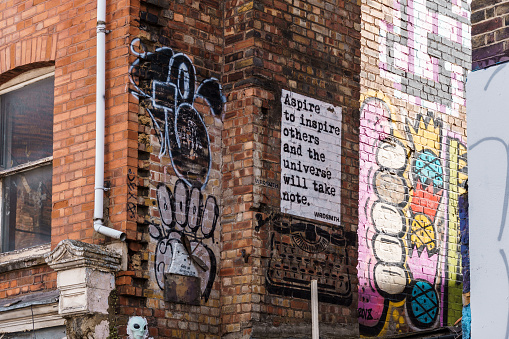 London, UK - August 25, 2023: Graffiti painted on wall in Brick Lane in Shoreditch area