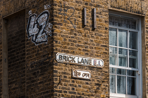 London, UK - August 25, 2023: Brick Lane Street Name Sign on brick wall