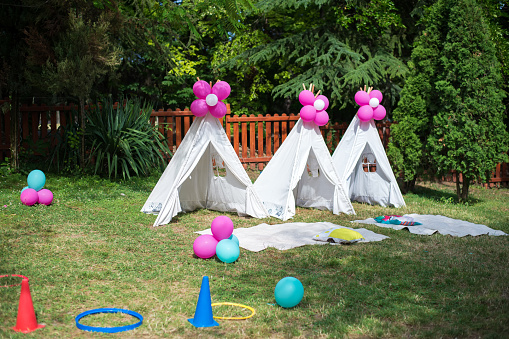 Garden exterior with playground and tents