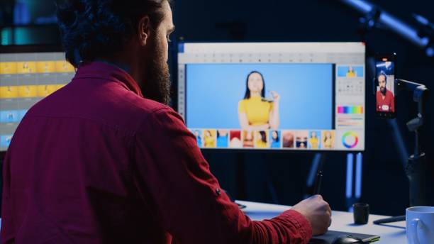 istock Photographer using smartphone selfie camera to film content, discussing image retouching software 1811716375