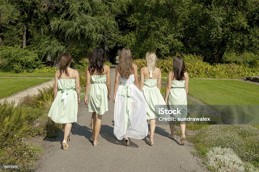 Girls walking in park Group of Girls in summer dresses walking in park Activity Stock Photo