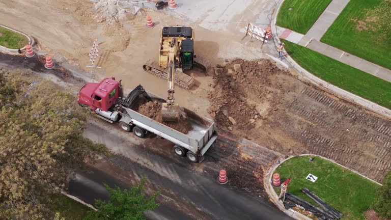 Aerial wide shot over of road construction process in suburbs area