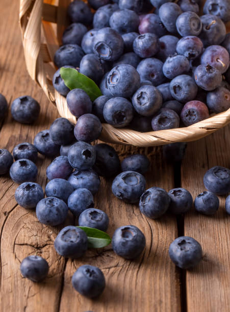 istock Blueberries in basket on wooden table 1811759363