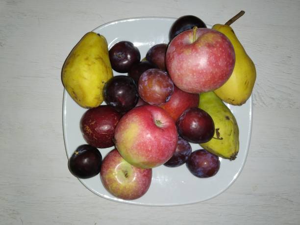 istock Plate of fresh fruit on a wooden table. Top view. 1811770271