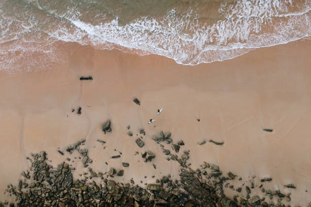 istock Beach with surfers from above 1811832387