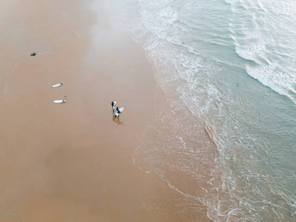 istock Beach with surfers from above 1811832415