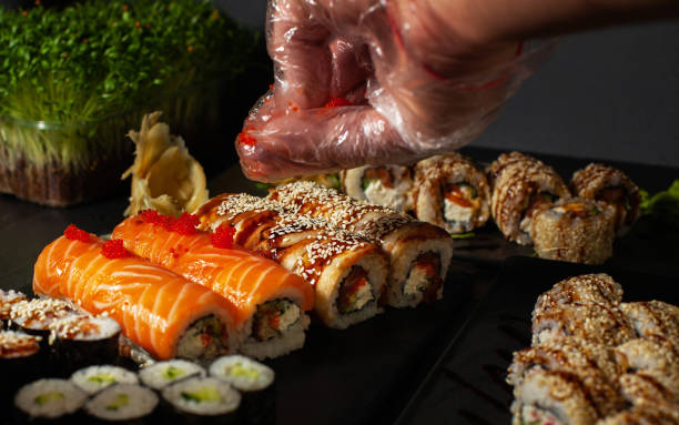 istock sushi rolls of various types that the cook sprinkles with sesame seeds before serving 1811835391