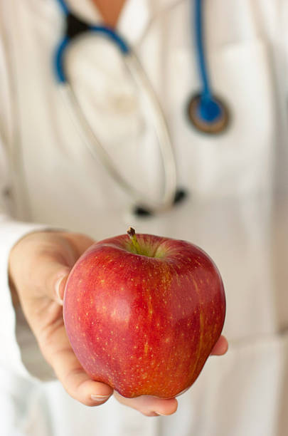istock Doctor. Apple. Health 181184054