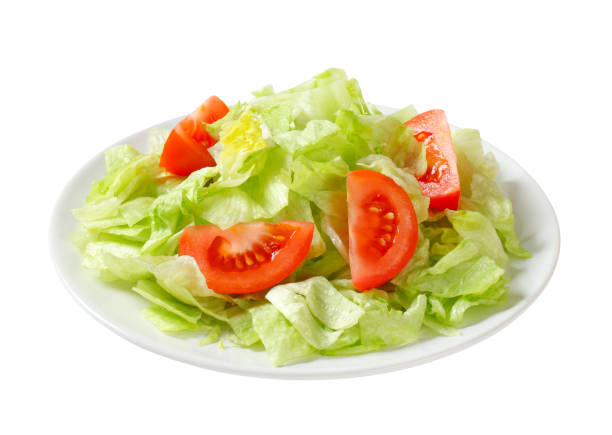 Ice lettuce and tomato wedges Ice lettuce leaves with tomato wedges side salad stock pictures, royalty-free photos & images