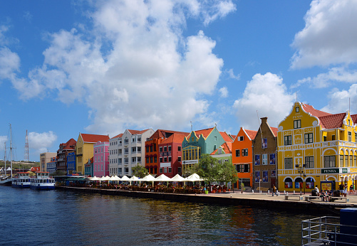 Willemstad, Curaçao, Kingdom of the Netherlands: Punda (Dutch: De Punt) is the oldest district of Willemstad  the capital of Curaçao . The district was originally called De Punt, which was translated into Papiamento as Punta and later corrupted to Punda. Punda is located east of Sint Anna Bay, and together with Otrobanda ('De Overkant'), located west of Sint Anna Bay, it forms the historic city center of Willemstad. Punda and Otrobanda have been on the UNESCO World Heritage List since 1997.