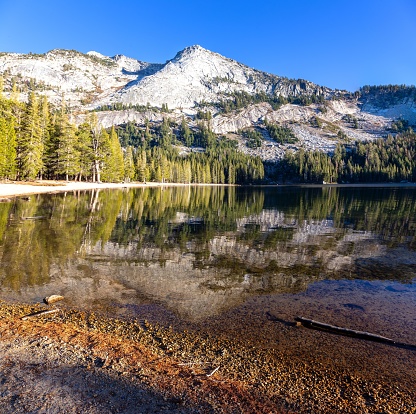 Californian Sierra Nevada Granite Mountain Peak Reflection in Treelined Tenaya Lake Calm Water