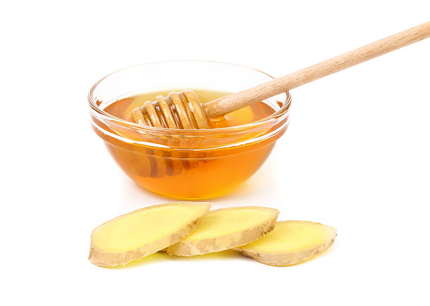 istock Honey in bowl and a slices ginger root. 181186856