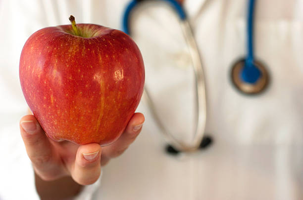 istock Doctor holding an apple in his hand. 181187138