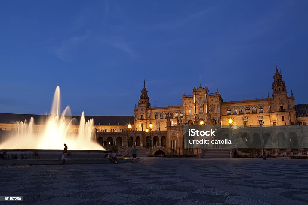 Fonte da Plaza de Espana, em Sevilha, à noite - Foto de stock de Amarelo royalty-free