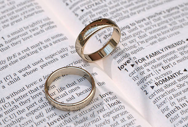istock Wedding rings on a dictionary page showing love 181188053