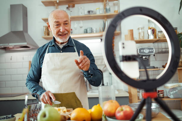 istock Senior chef vlogging about healthy meals from domestic kitchen 1811932522