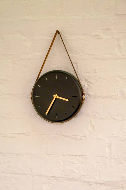 istock wall clock machine on a white background. elegant wall clock hung on a leather strap 1811942066