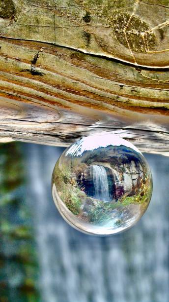 istock looking glass falls is inverted while looking through one crystal glass orb ball. 1811972474