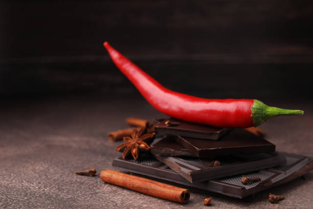 istock Delicious chocolate, fresh chili pepper and spices on grey textured table, closeup. Space for text 1812001016