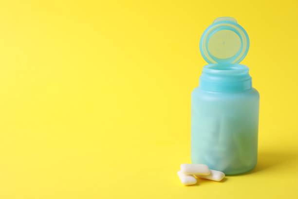 istock Jar with chewing gums on yellow background. Space for text 1812020138