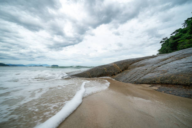 Free Stock Photo of Rocks and Water on Beach Under Cloudy Sky ...