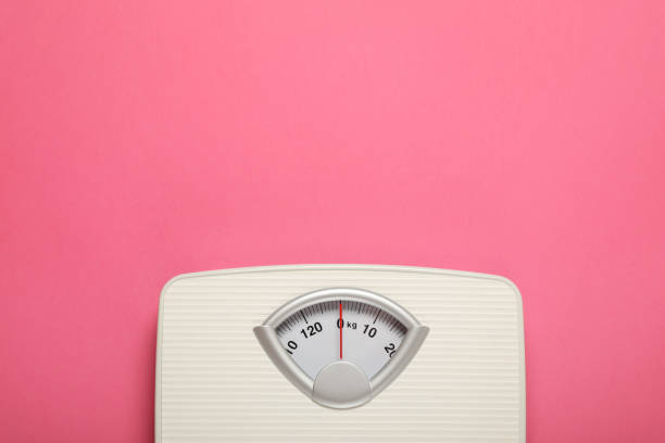 istock Weigh scales on pink background, top view with space for text. Overweight concept 1812038103
