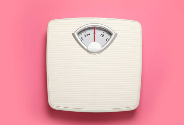 istock Weigh scales on pink background, top view. Overweight concept 1812038105
