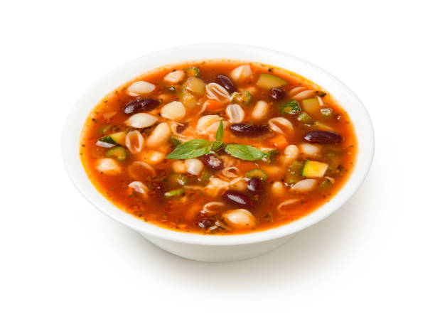 Italian minestrone soup in a white porcelain soup bowl isolated on a white background. stock photo