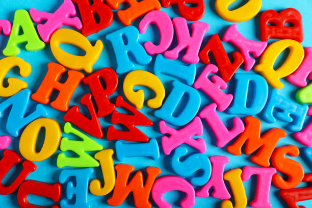 istock Many colorful magnetic letters on light blue background, flat lay 1812051900