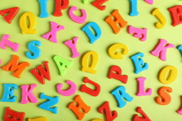 istock Many colorful magnetic letters on light green background, flat lay 1812052434