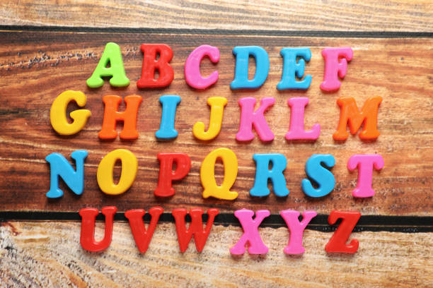 istock Colorful magnetic letters on wooden table, flat lay. Alphabetical order 1812056135
