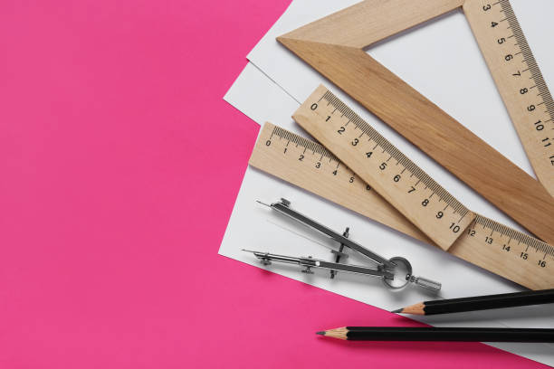 istock Different rulers, pencils and compass on pink background, flat lay. Space for text 1812059989