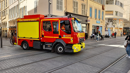 Marseille, France - April 17, 2023: Marins-Pompiers De Marseille, Marseille Fire Truck, Building Exterior, Retail Store, People Walking, Railroard Track Scene In French Riviera, Europe