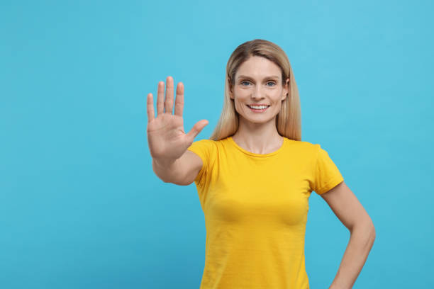 istock Woman giving high five on light blue background. Space for text 1812105420