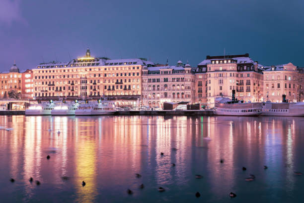 istock View of illuminated buildings at waterfront 1812115914