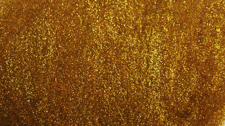 Gold glitter background with sparkling texture.