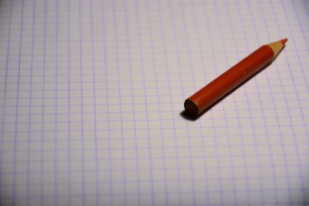 istock A red pencil lying on a sheet of paper 1812144070