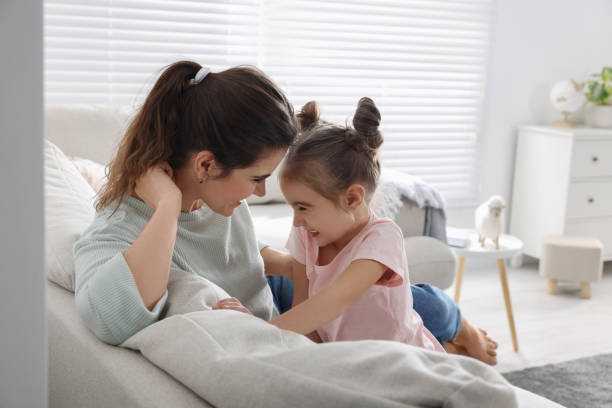 istock Young mother and her daughter spending time together on sofa at home 1812144617
